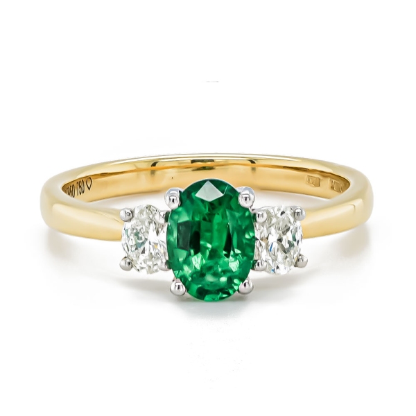 18ct and Platinum Oval Emerald and Two Oval Diamond Ring
